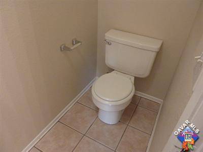 1539 Kings Road Palmdale, CA 93551 - Photo 12 of 22 a white toilet sitting next to a small bathroom
