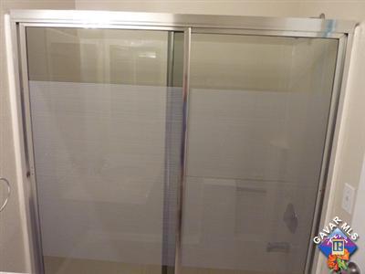 1539 Kings Road Palmdale, CA 93551 - Photo 18 of 22 a bathroom with a glass shower door
