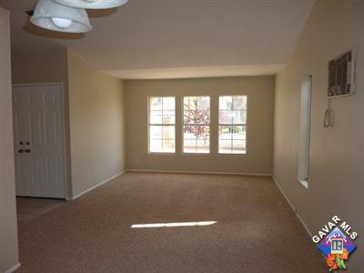 1539 Kings Road Palmdale, CA 93551 - Photo 4 of 22 an empty room with windows and chandelier fan
