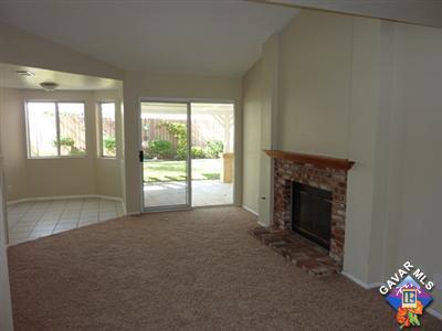 1539 Kings Road Palmdale, CA 93551 - Photo 5 of 22 a view of an empty room with a fireplace and a window