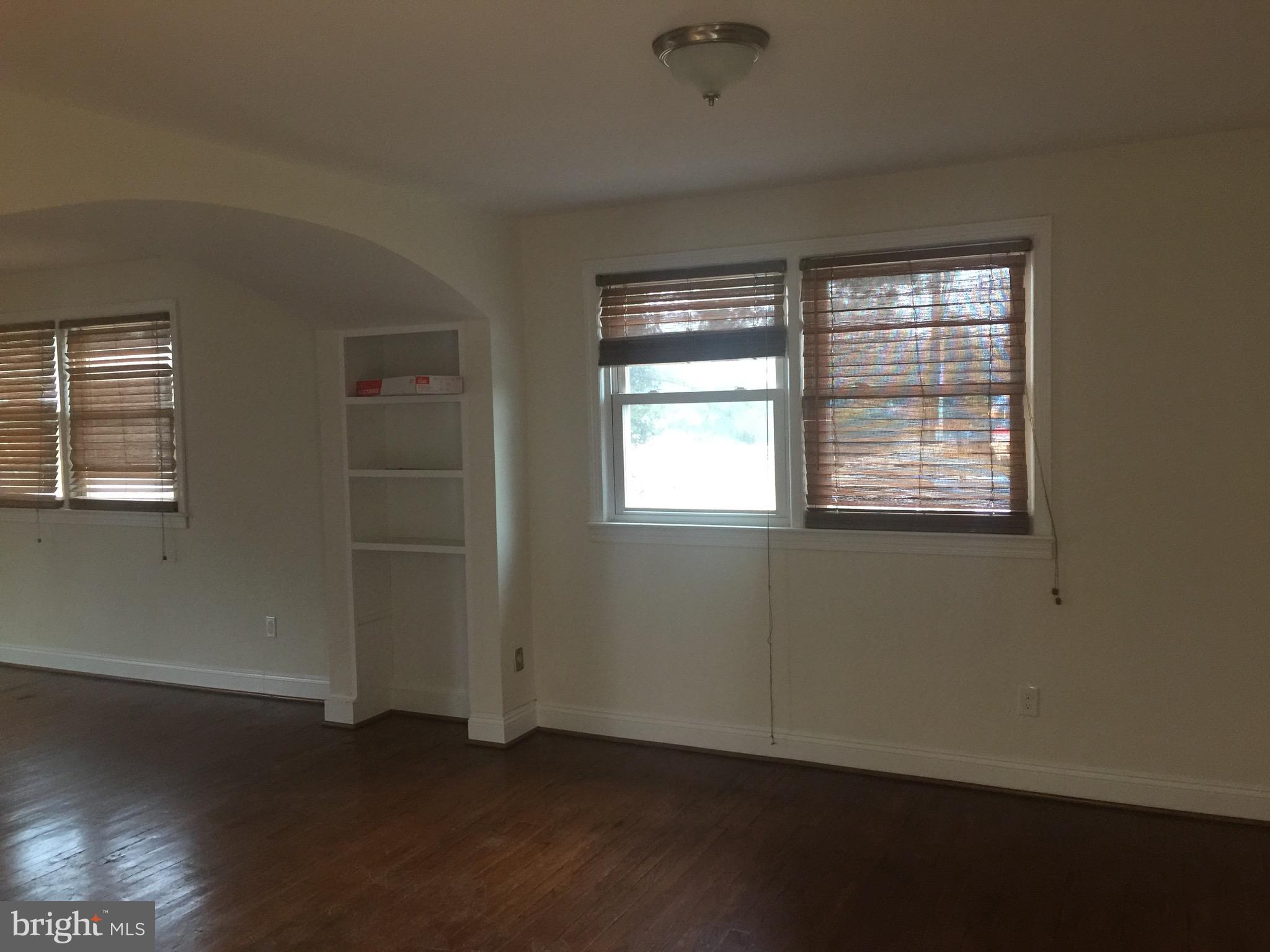 9101 Sudley Road Manassas, VA 20110 - Photo 11 of 16 an empty room with wooden floor and windows