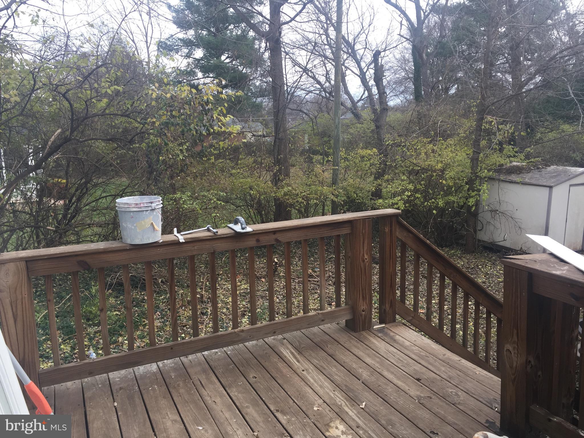9101 Sudley Road Manassas, VA 20110 - Photo 15 of 16 a wooden deck with trees in front of it