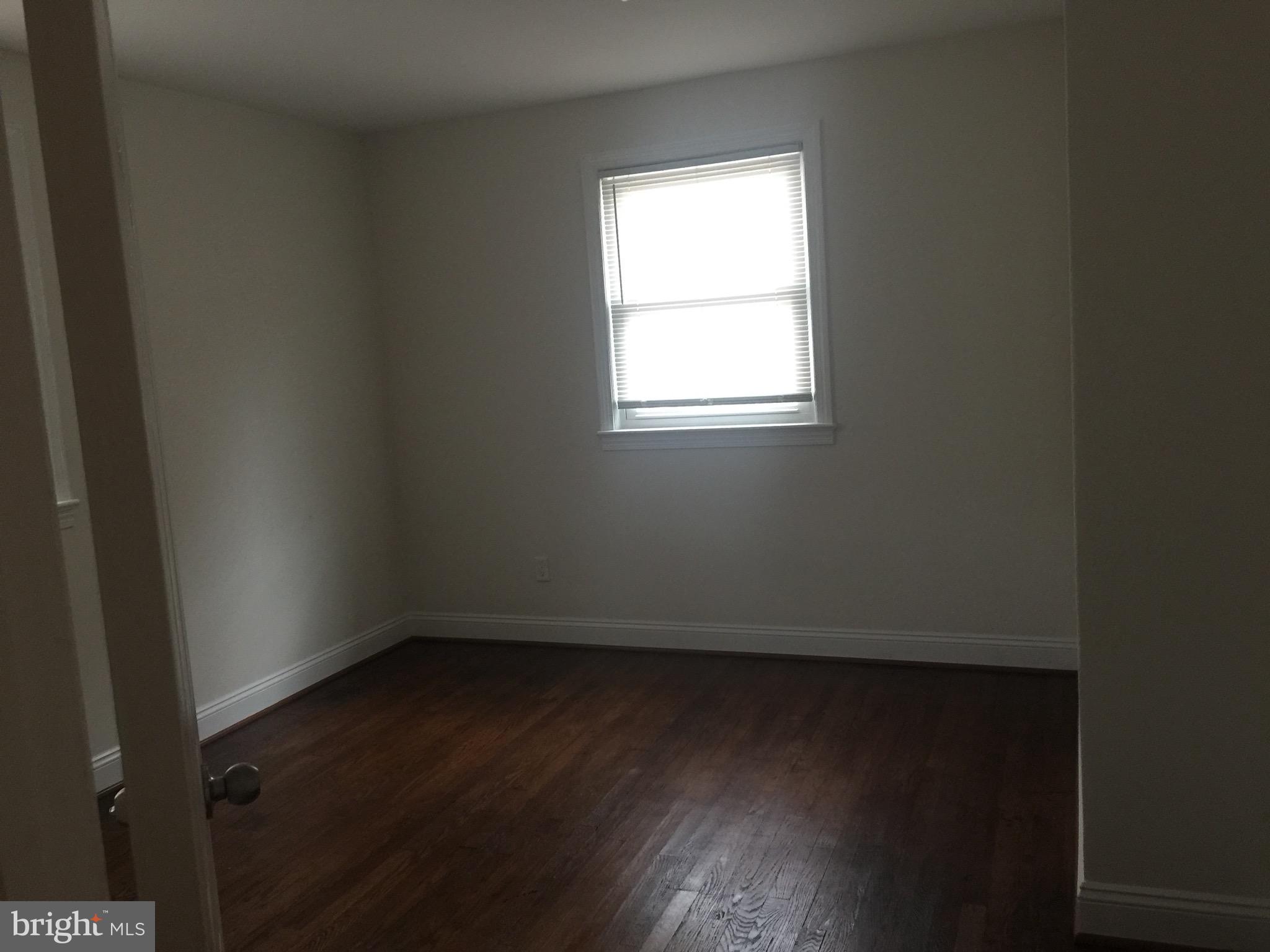 9101 Sudley Road Manassas, VA 20110 - Photo 6 of 16 an empty room with wooden floor and windows