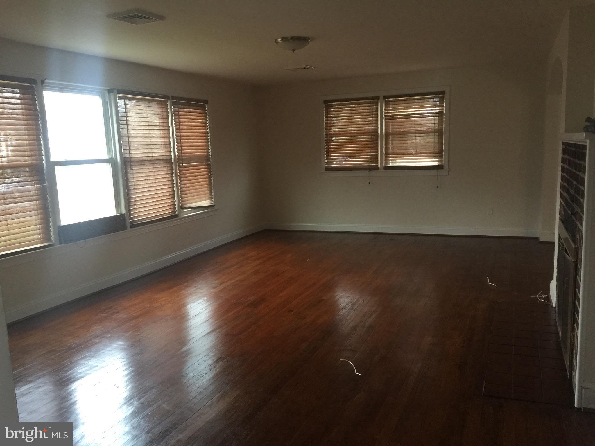 9101 Sudley Road Manassas, VA 20110 - Photo 9 of 16 an empty room with wooden floor and windows