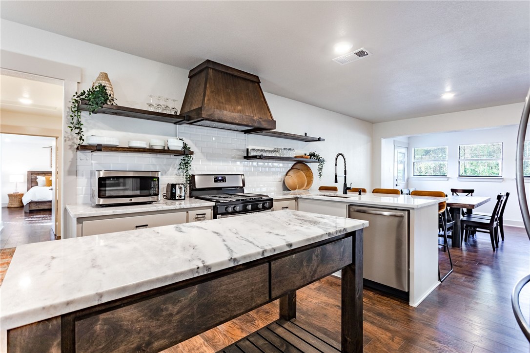 107 Spring Creek Street Waco, TX 76705 - Photo 26 of 78 a kitchen with a sink a stove and chairs