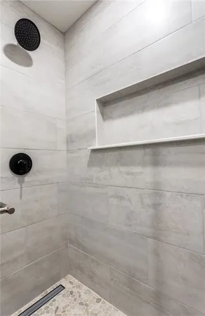 a bedroom with a bed chandelier and a window