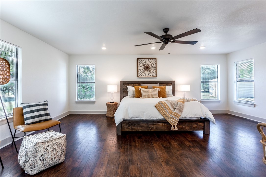 107 Spring Creek Street Waco, TX 76705 - Photo 32 of 78 a bedroom with a bed and wooden floor