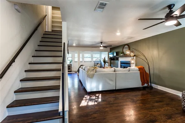 a bedroom with a bed and a lamp on dresser
