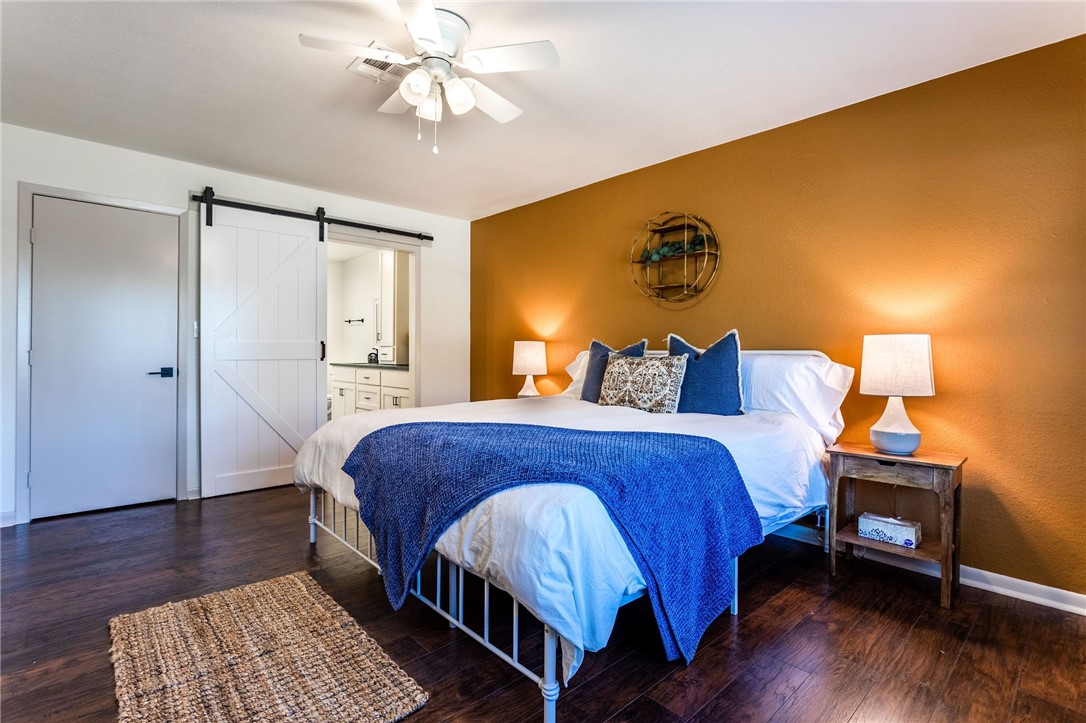 107 Spring Creek Street Waco, TX 76705 - Photo 44 of 78 a bedroom with a bed chandelier and a window
