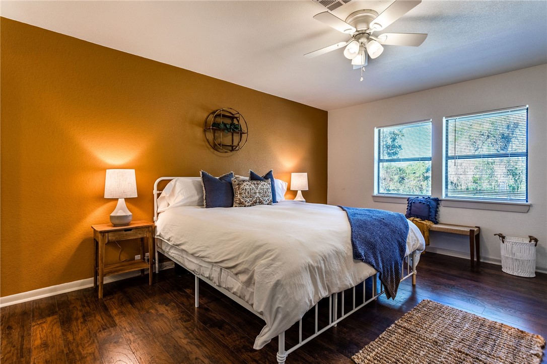 107 Spring Creek Street Waco, TX 76705 - Photo 45 of 78 a bedroom with a bed and a chandelier