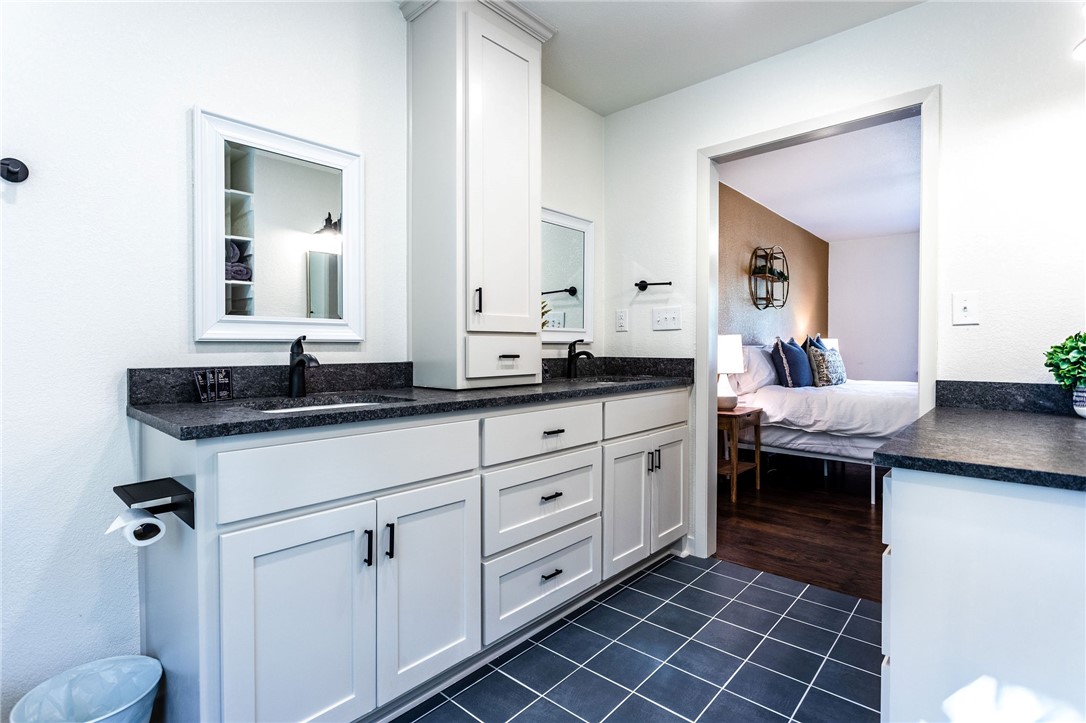 107 Spring Creek Street Waco, TX 76705 - Photo 51 of 78 a spacious bathroom with a granite countertop sink mirror and