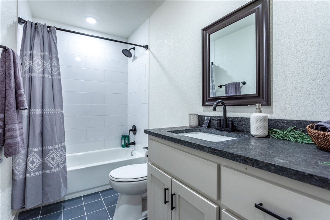 107 Spring Creek Street Waco, TX 76705 - Photo 55 of 78 a bathroom with a granite countertop sink toilet and shower
