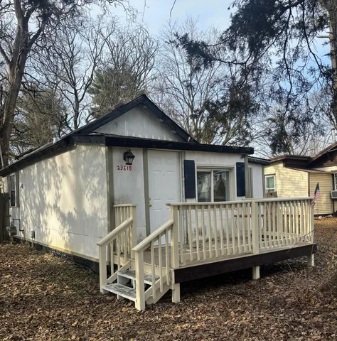 a view of a house with a yard and deck
