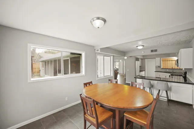 a kitchen with granite countertop white cabinets and white appliances