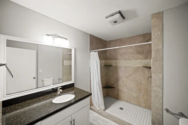 a bedroom with a bed and a chair