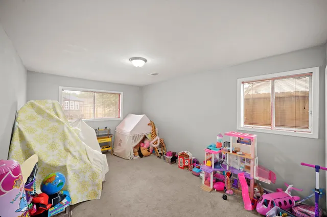 a bathroom with a granite countertop sink a mirror and shower