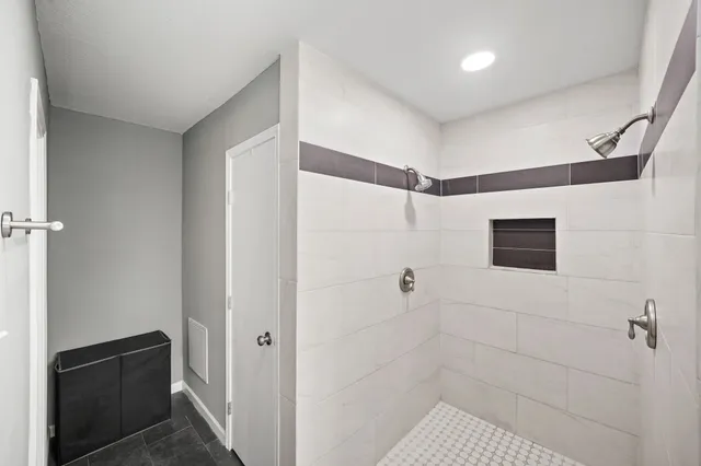 a bathroom with a shower and a sink