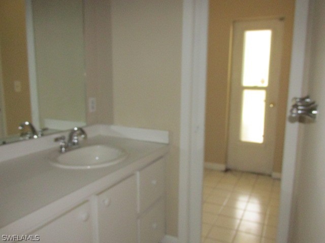 19185 Coconut Road Fort Myers, FL 33967 - Photo 12 of 13 a bathroom with a sink and a mirror