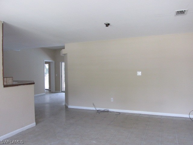 19185 Coconut Road Fort Myers, FL 33967 - Photo 4 of 13 a view of an empty room with wooden floor and windows