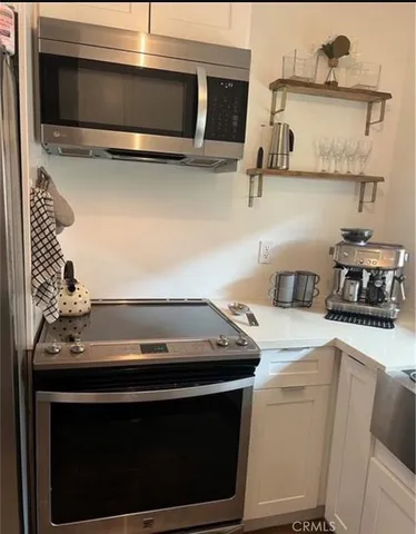 a kitchen with a stove and a microwave