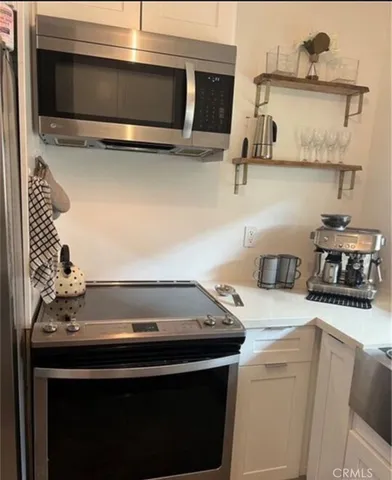 a kitchen with a stove and a microwave