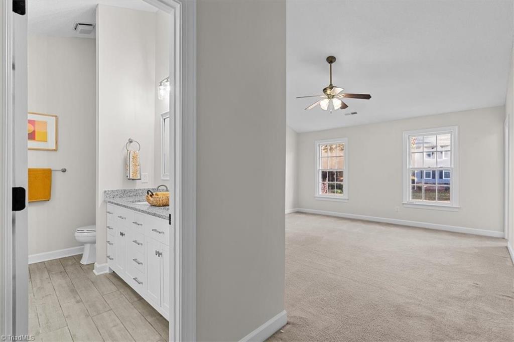 3329 Cardinal Ridge Drive Greensboro, NC 27410 - Photo 26 of 45 Primary bathroom is tucked away in the large bedroom.