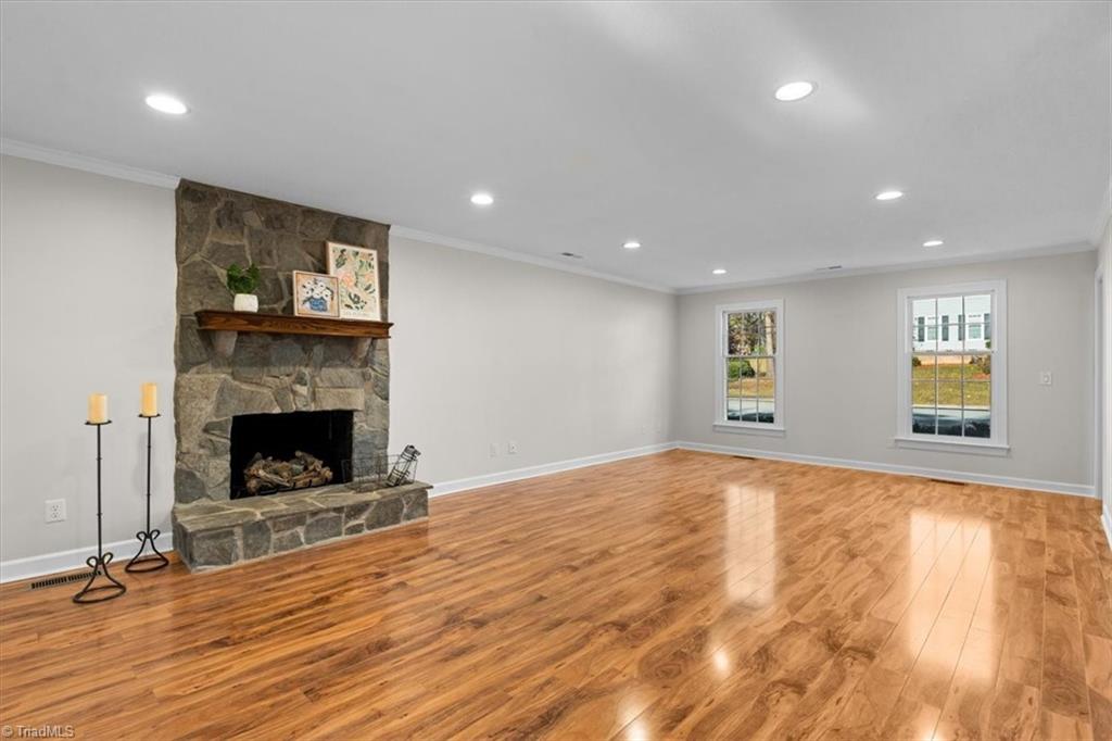 3329 Cardinal Ridge Drive Greensboro, NC 27410 - Photo 3 of 45 Cozy gas fireplace is the focal point of this space. The room can be divided into living room and den or a dining room with a fireplace.