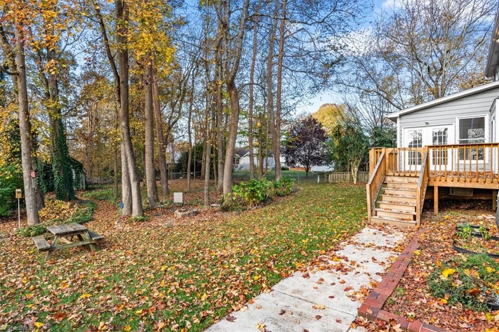 3329 Cardinal Ridge Drive Greensboro, NC 27410 - Photo 38 of 45 Step down from the deck and enjoy this marvelous yard!