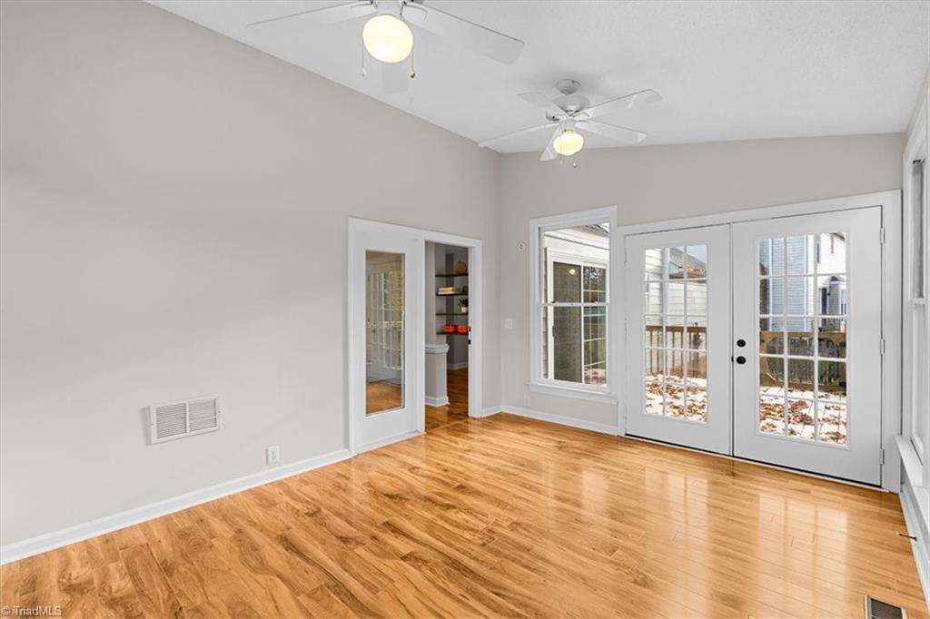 3329 Cardinal Ridge Drive Greensboro, NC 27410 - Photo 6 of 45 You will LOVE this sunroom! Vaulted ceilings, fans, and access to the deck will make this one of your favorite spots in the house.