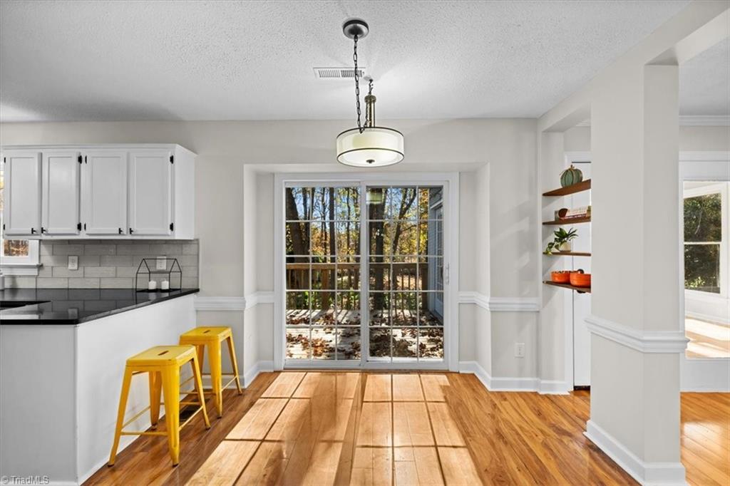3329 Cardinal Ridge Drive Greensboro, NC 27410 - Photo 10 of 45 Step inside from the deck into this bright, wonderful kitchen with plenty of space for a table or moveable island.