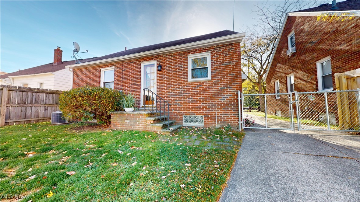 22581 Chardon Road Euclid, OH 44117 - Photo 28 of 34 Rear view of house with a lawn