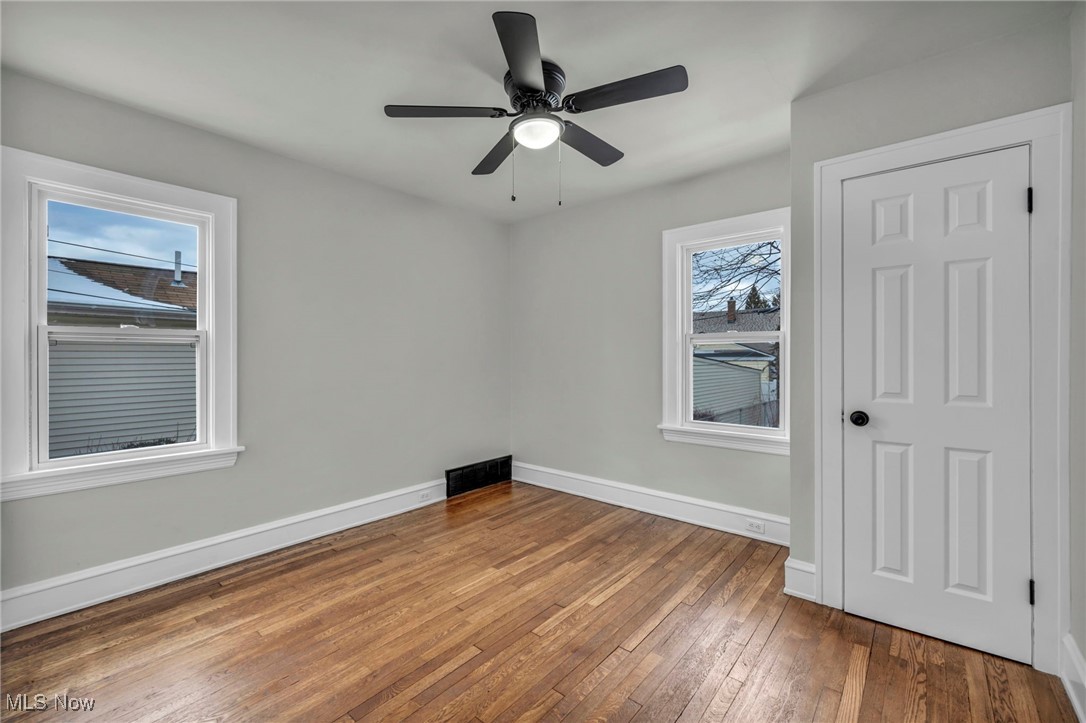 3577 Warren Road Cleveland, OH 44111 - Photo 11 of 17 Spare room with a ceiling fan, visible vents, baseboards, and hardwood / wood-style floors