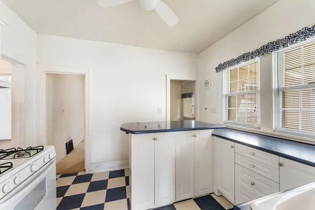 a kitchen with granite countertop cabinets and window