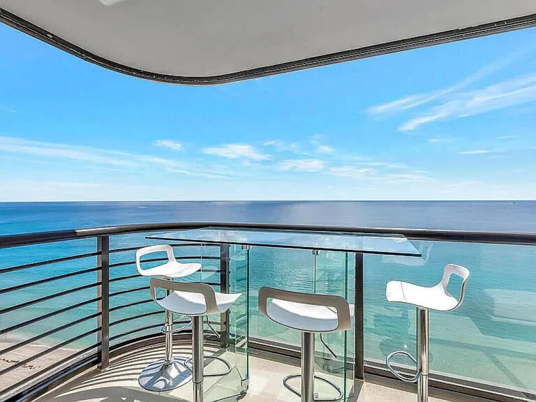 250 South Ocean Boulevard, Unit 11F Boca Raton, FL 33432 - Photo 16 of 45 a balcony with a table and chairs