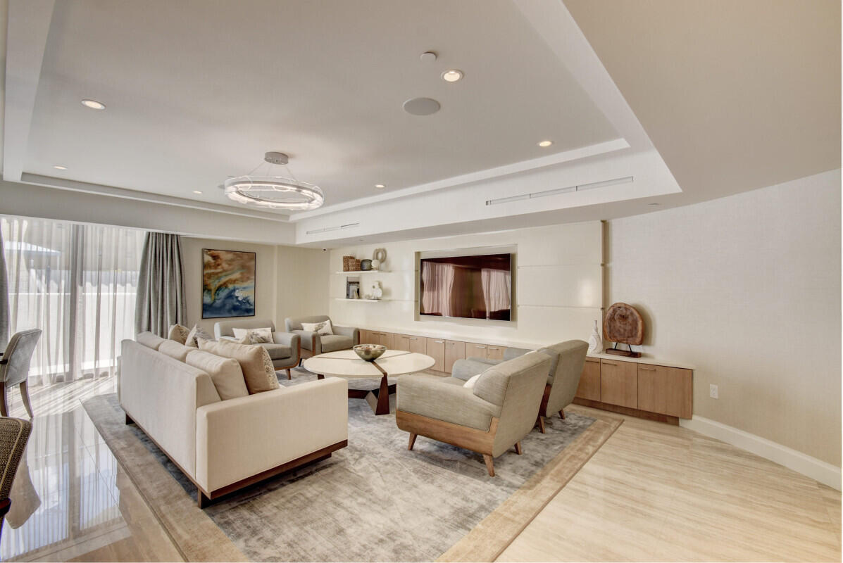 250 South Ocean Boulevard, Unit 11F Boca Raton, FL 33432 - Photo 25 of 45 a living room with furniture and a flat screen tv