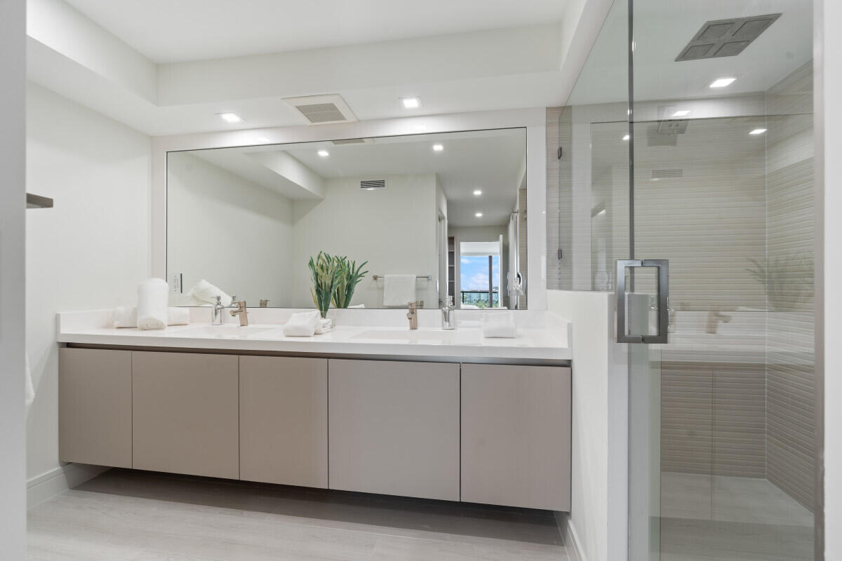 250 South Ocean Boulevard, Unit 11F Boca Raton, FL 33432 - Photo 10 of 45 a bathroom with a granite countertop sink mirror and double