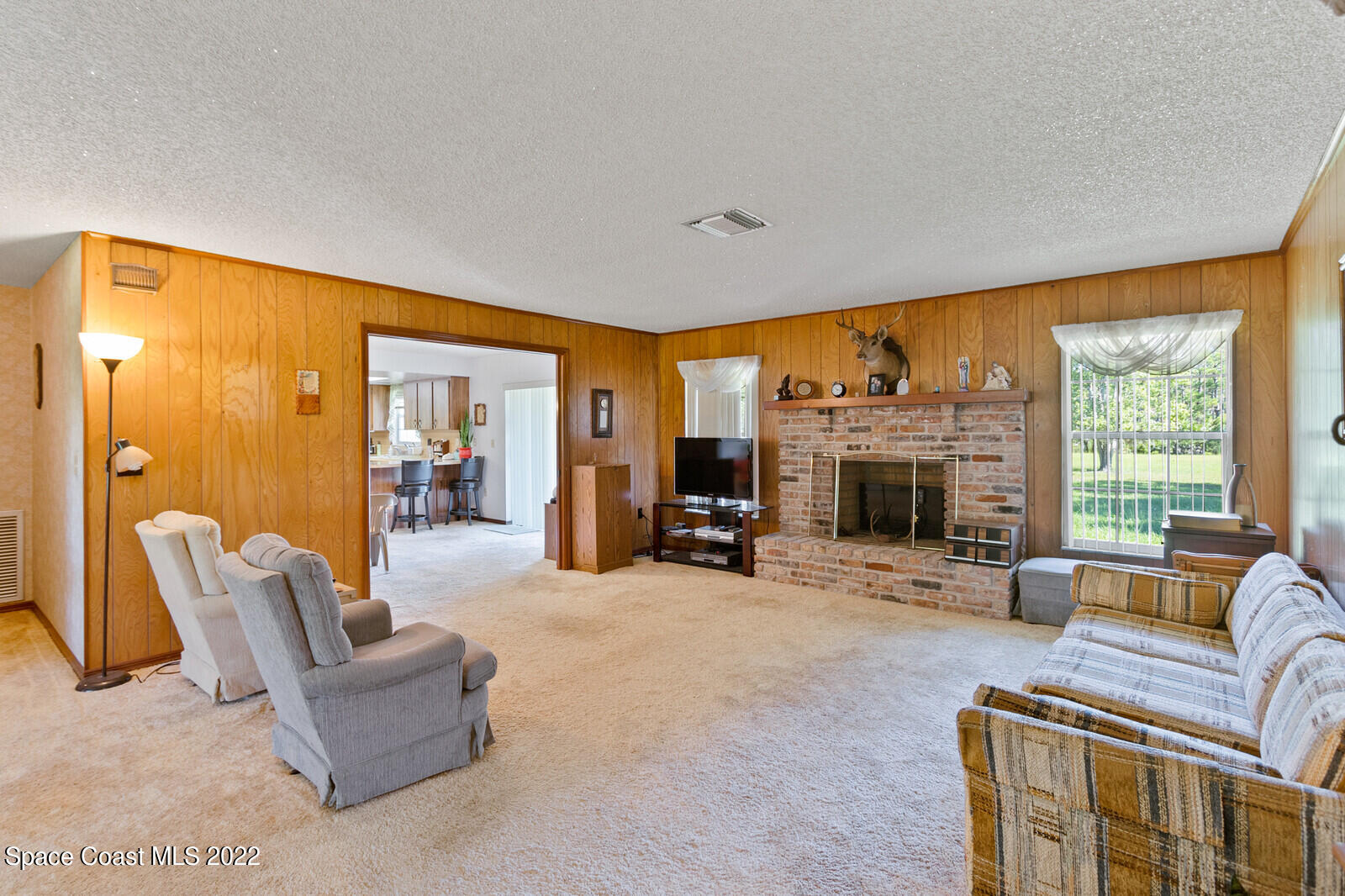 200 Atz Road Malabar, FL 32950 - Photo 19 of 30 a living room with furniture a fireplace and a large window