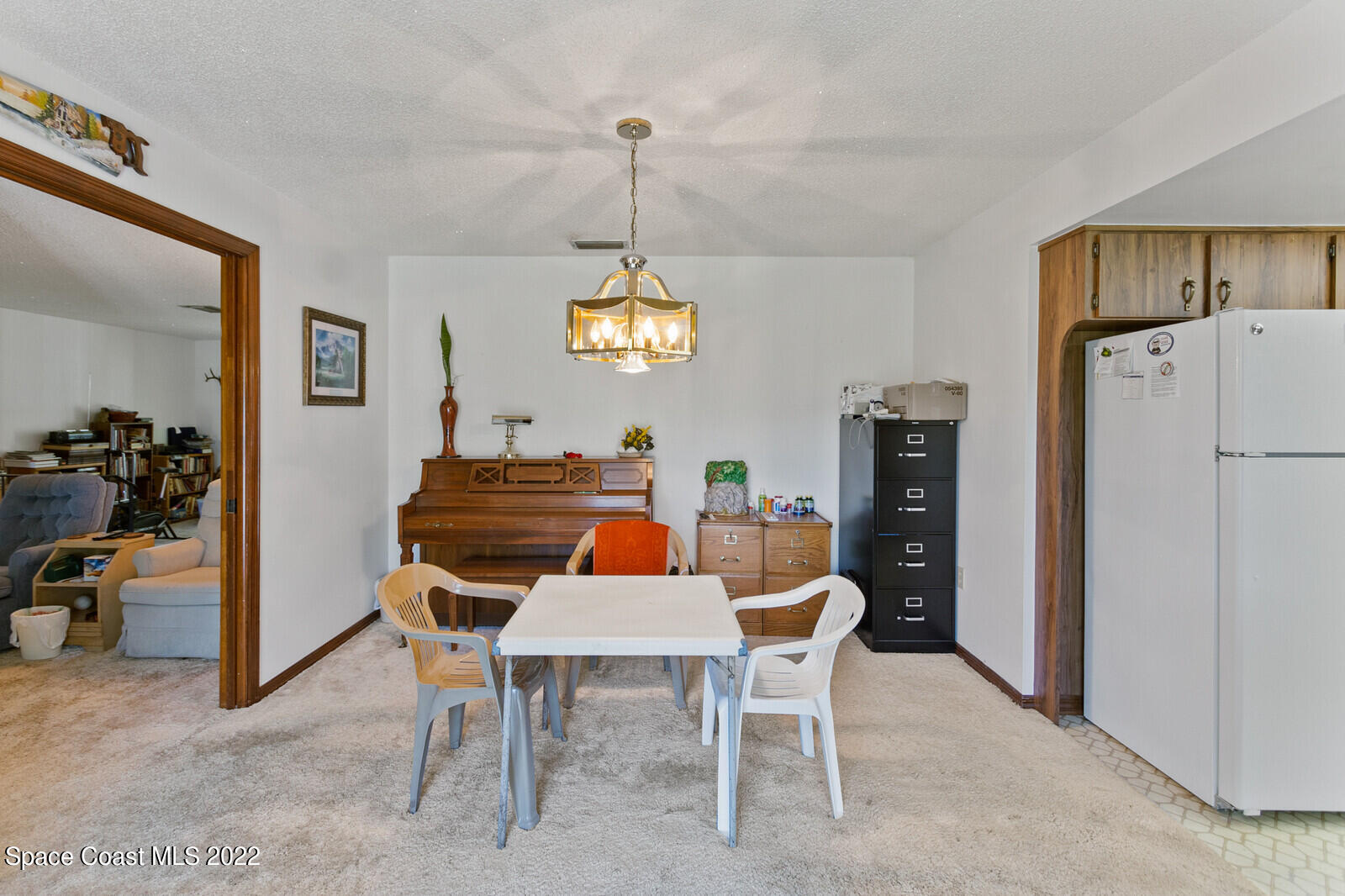 200 Atz Road Malabar, FL 32950 - Photo 21 of 30 a view of a dining room with furniture window and a chandelier
