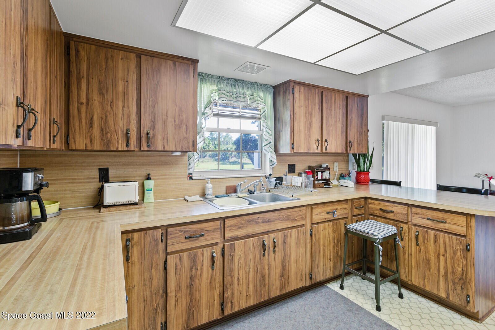 200 Atz Road Malabar, FL 32950 - Photo 23 of 30 a kitchen with a sink stove and cabinets