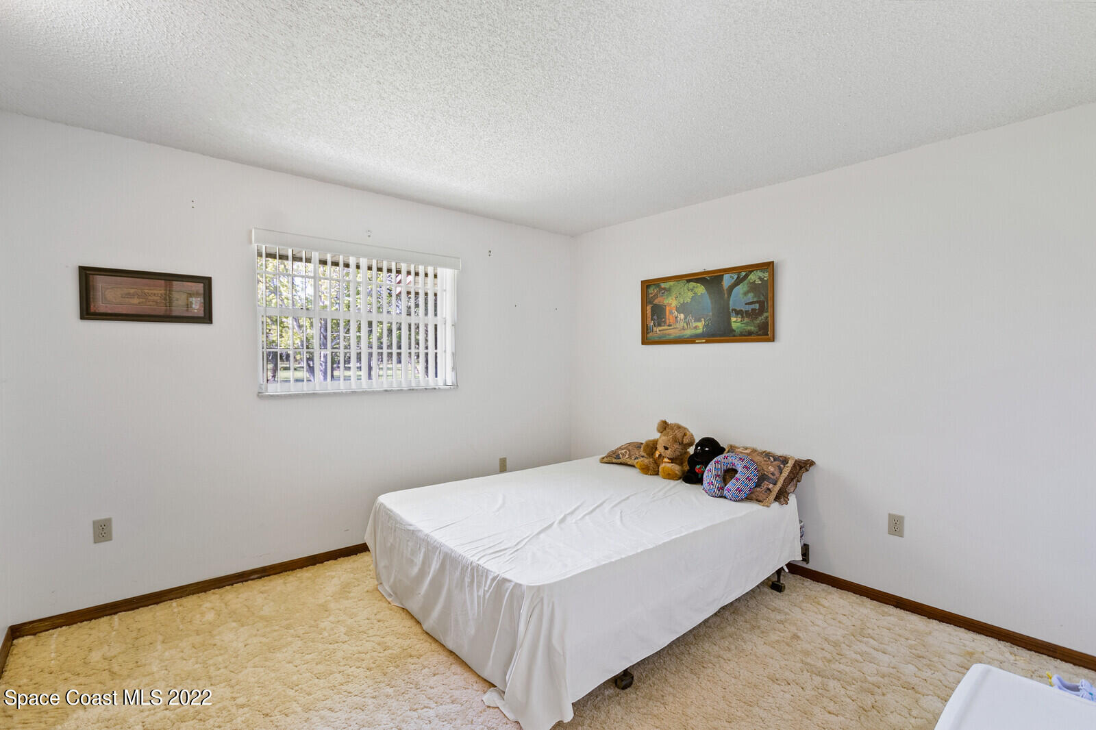200 Atz Road Malabar, FL 32950 - Photo 27 of 30 a bedroom with a bed and painting on the wall