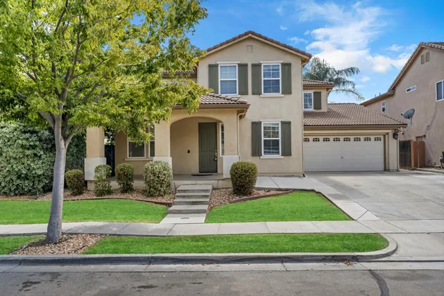 a front view of a house with a yard