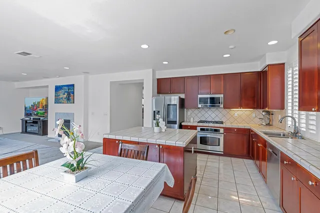 a large kitchen with a table and chairs