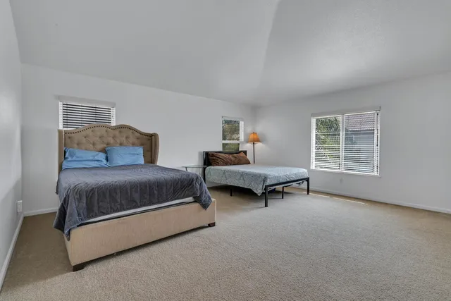 a bedroom with a bed and window