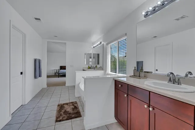 a bathroom with a bathtub a sink and a window