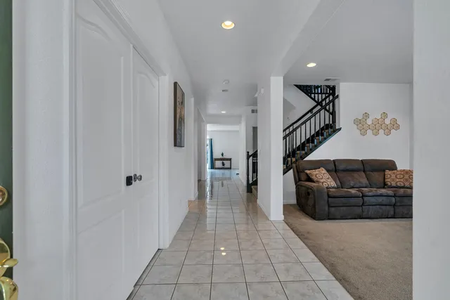 a living room with furniture and a ceiling fan