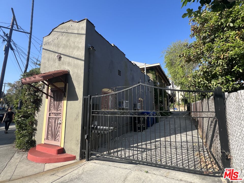 a view of a house with wooden fence
