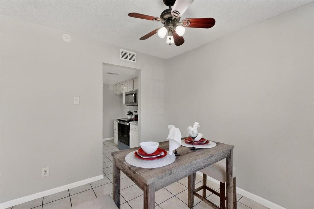 11311 Audelia Road, Unit 165 Dallas, TX 75243 - Photo 13 of 31 Dining area with a textured ceiling, a ceiling fan, and light tile patterned flooring