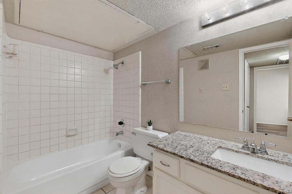 11311 Audelia Road, Unit 165 Dallas, TX 75243 - Photo 25 of 31 Bathroom featuring a textured wall, a textured ceiling, vanity, and shower / tub combination
