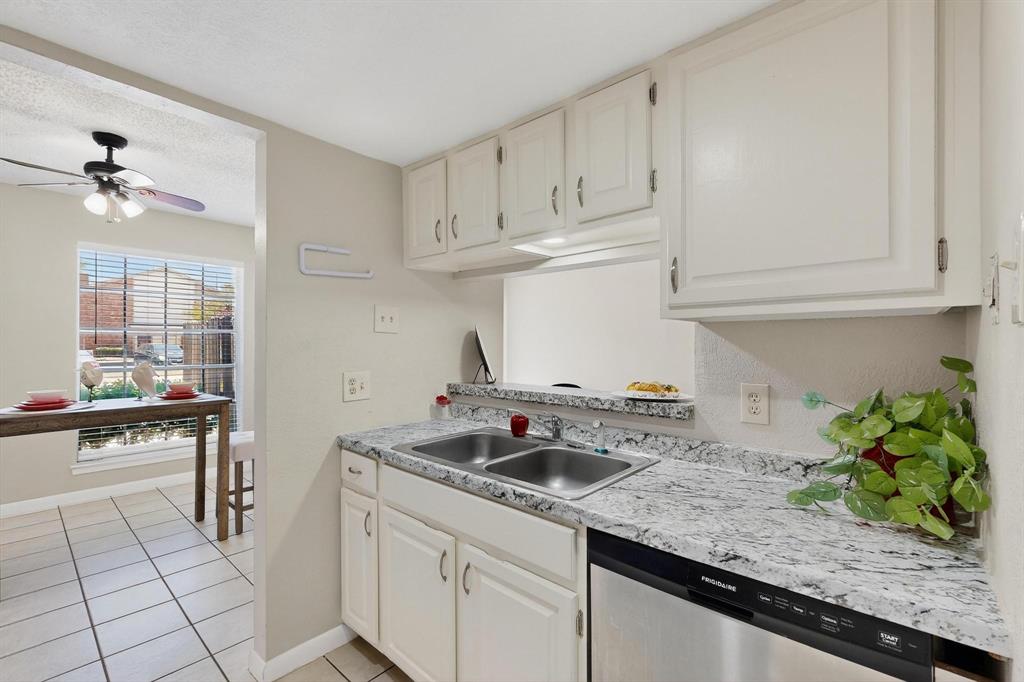 11311 Audelia Road, Unit 165 Dallas, TX 75243 - Photo 3 of 31 Kitchen with dishwasher, light countertops, a ceiling fan, white cabinets, and a textured ceiling
