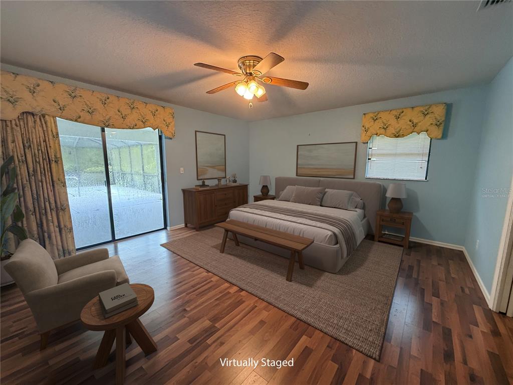 19260 Northwest 88th Avenue Road Reddick, FL 32686 - Photo 11 of 41 a bedroom with a bed and wooden floor